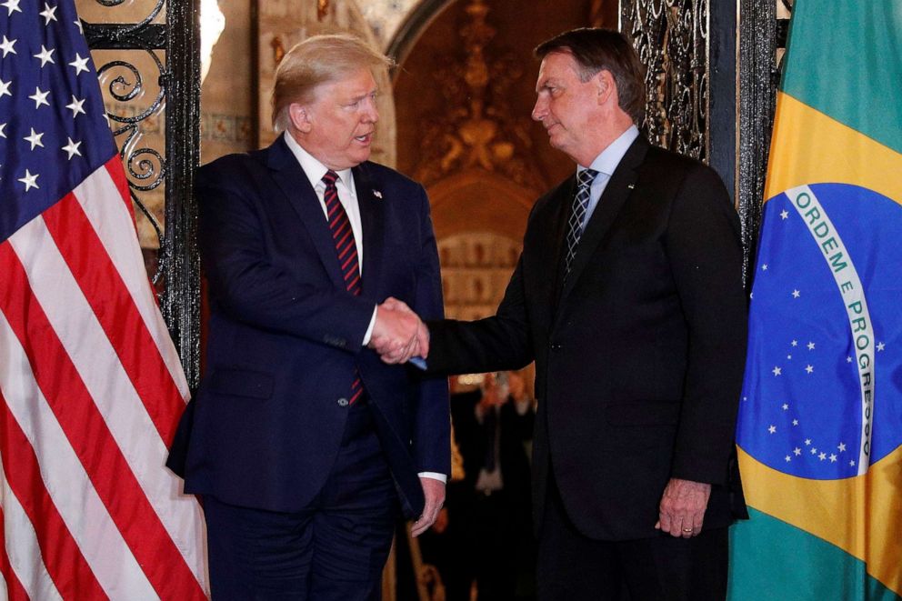 PHOTO: President Donald Trump shakes hands with Brazilian President Jair Bolsonaro before attending a working dinner at the Mar-a-Lago resort in Palm Beach, Fla., March 7, 2020. 