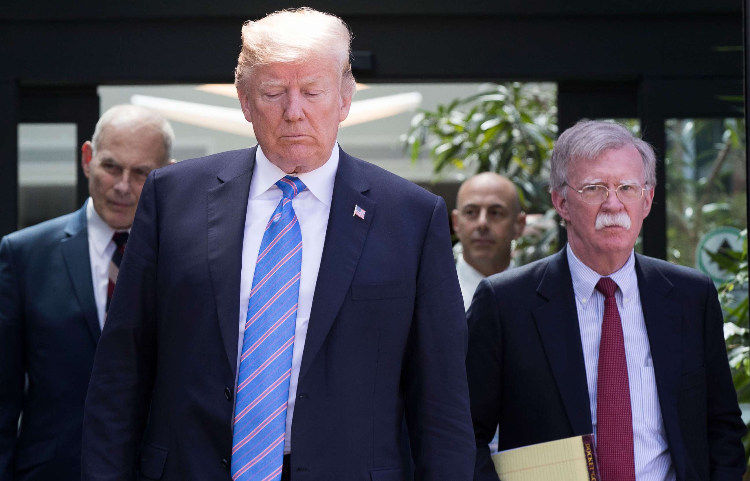 PHOTO: In this June 9, 2018, file photo, President Donald Trump, with National Security Advisor John Bolton (R) and White House Chief of Staff John Kelly (L), leaves the G7 summit in La Malbaie, Quebec.