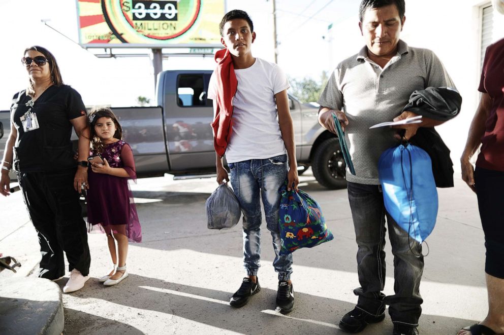 PHOTO: Guatemalan asylum seekers hold their belongings as they prepare to board a bus to meet their sponsors in Las Vegas, on May 16, 2019, in Las Cruces, N.M. 