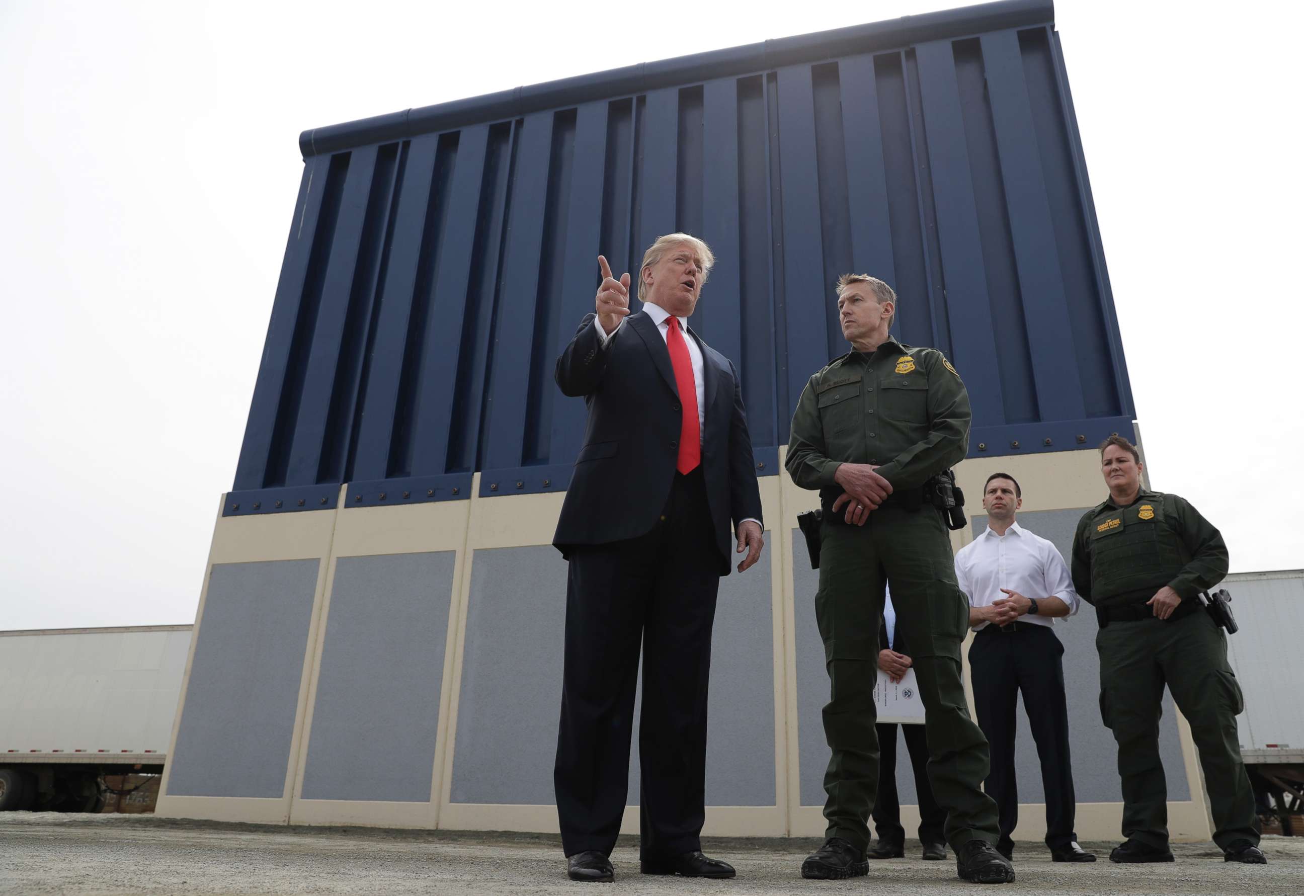 PHOTO: President Donald Trump speaks during a tour to review border wall prototypes, March 13, 2018, in San Diego, as Rodney Scott, the Border Patrol's San Diego sector chief, listens. 