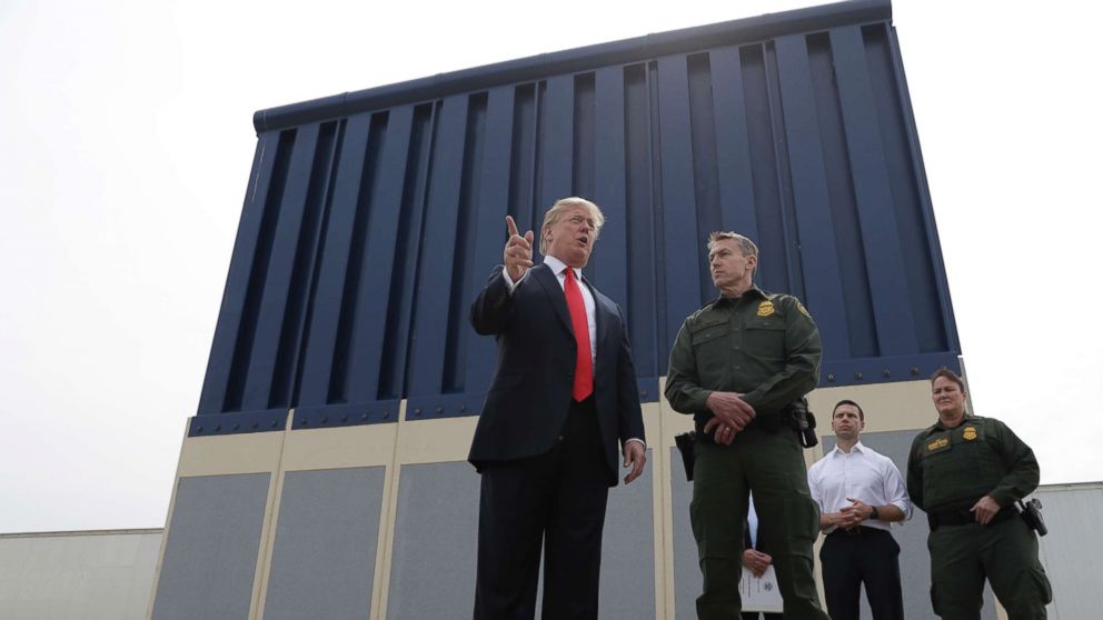 PHOTO: President Donald Trump speaks during a tour to review border wall prototypes, March 13, 2018, in San Diego, as Rodney Scott, the Border Patrol's San Diego sector chief, listens. 