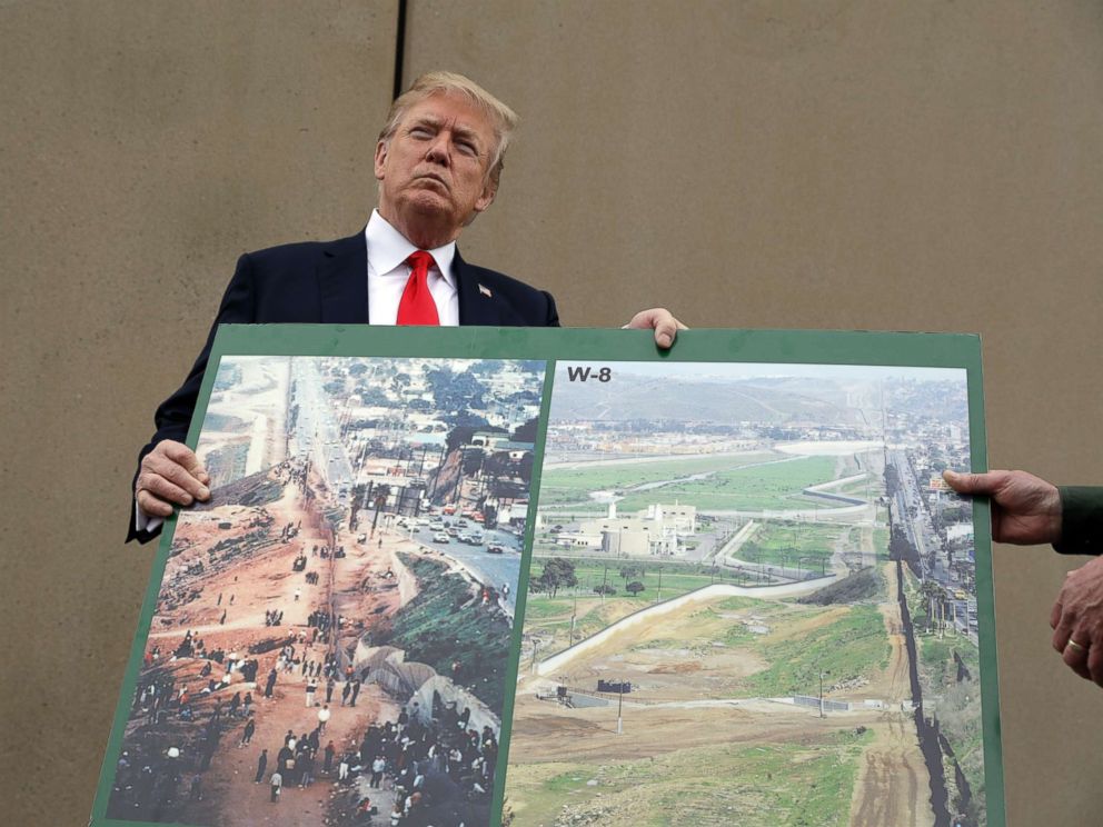 PHOTO: President Donald Trump holds an image of the border area as he speaks during a tour to review border wall prototypes, March 13, 2018, in San Diego.