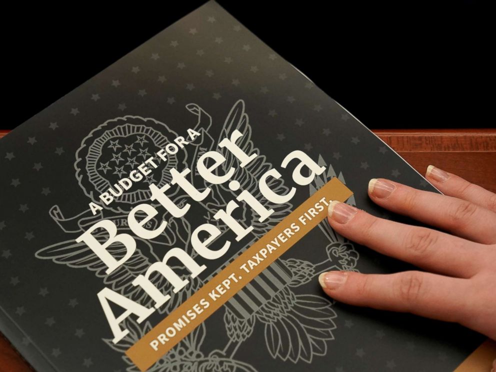 PHOTO: An aide puts her hand on a copy of Volume 1 of U.S. President Donald Trumps budget for Fiscal Year 2020 after it was delivered to the House Budget Committee room on Capitol Hill in Washington, March 11, 2019.