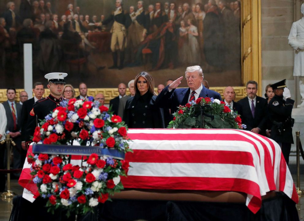 PHOTO: President Donald Trump salutes, as he and first lady Melania Trump pay their respects at the flag draped casket of former President George H.W. Bush, as it lies in state inside the U.S. Capitol Rotunda in Washington, Dec. 3, 2018.