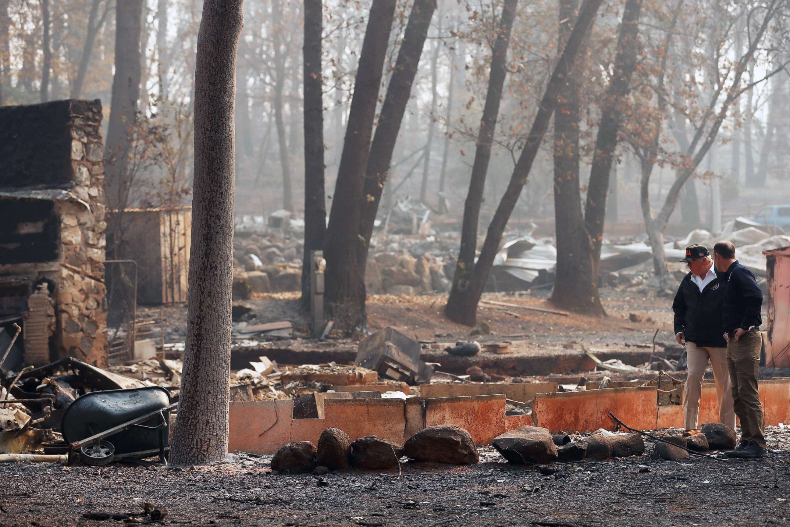 PHOTO: President Donald Trump visits the charred wreckage of Skyway Villa Mobile Home and RV Park with FEMA head Brock Long, right, in Paradise, Calif., Nov. 17, 2018.