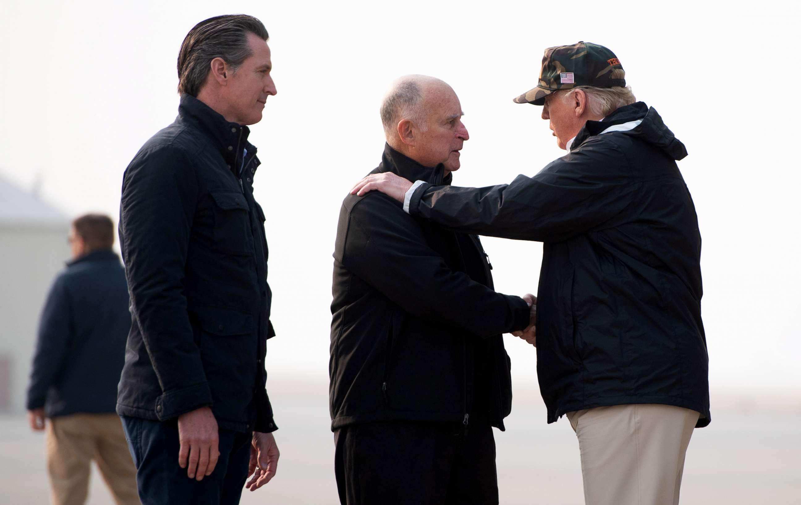PHOTO: President Donald Trump greets California Governor Jerry Brown and Governor-elect Gavin Newsom, left, as he arrives at Beale Air Force Base in California, Nov. 17, 2018.