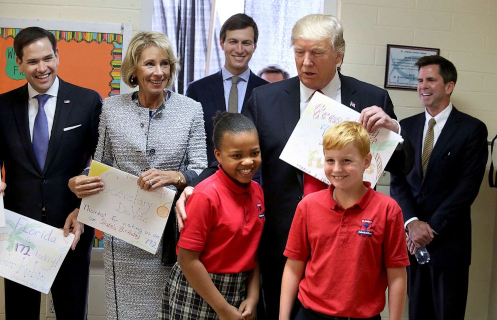 PHOTO: File photo of President Donald Trump thanking fourth-graders Janayah Chatelier and Landon Fritz for their homemade greeting cards during his visit to St. Andrew Catholic School in Orlando, Fla. on March 3, 2017.