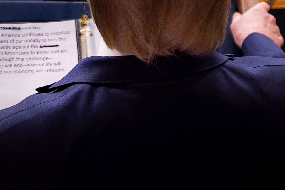 PHOTO: President Donald Trump looks at his notes showing the word "Chinese" crossed off, during his daily briefing on the novel coronavirus, COVID-19, at the White House, March 23, 2020, in Washington.