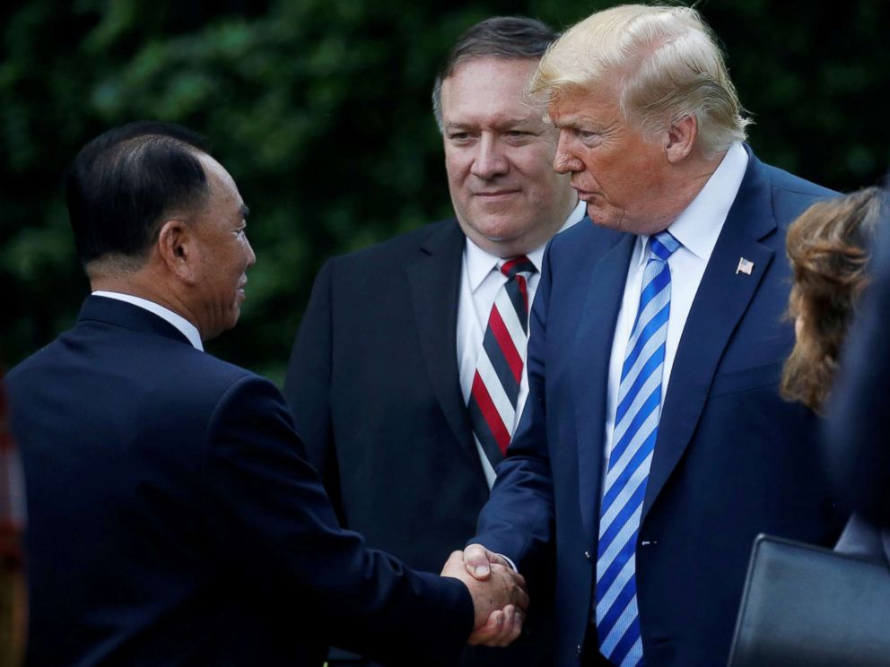 PHOTO: North Korean envoy Kim Yong Chol shakes hands with President Donald Trump as Secretary of State Mike Pompeo looks on after a meeting at the White House on June 1, 2018, in Washington, D.C.
