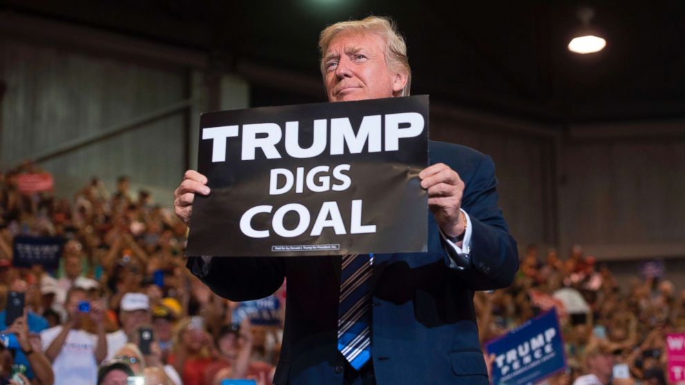 PHOTO: President Donald Trump holds up a "Trump Digs Coal" sign as he arrives to speak during a Make America Great Again Rally at Big Sandy Superstore Arena in Huntington, W. Va., Aug. 3, 2017.