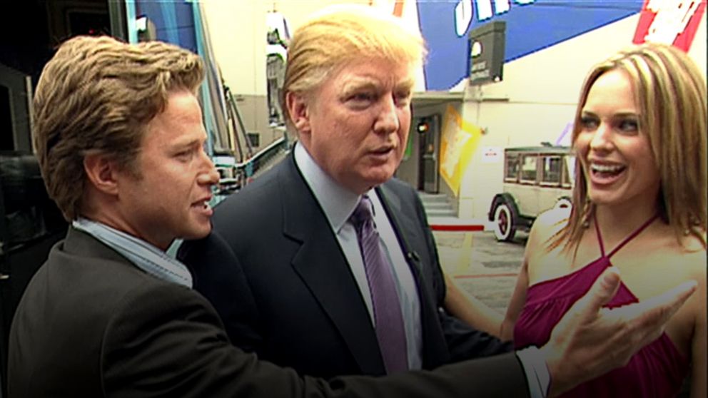 In this 2005 frame from video, Donald Trump prepares for an appearance on 'Days of Our Lives' with actress Arianne Zucker, right. He is accompanied to the set by Access Hollywood host Billy Bush, left. 