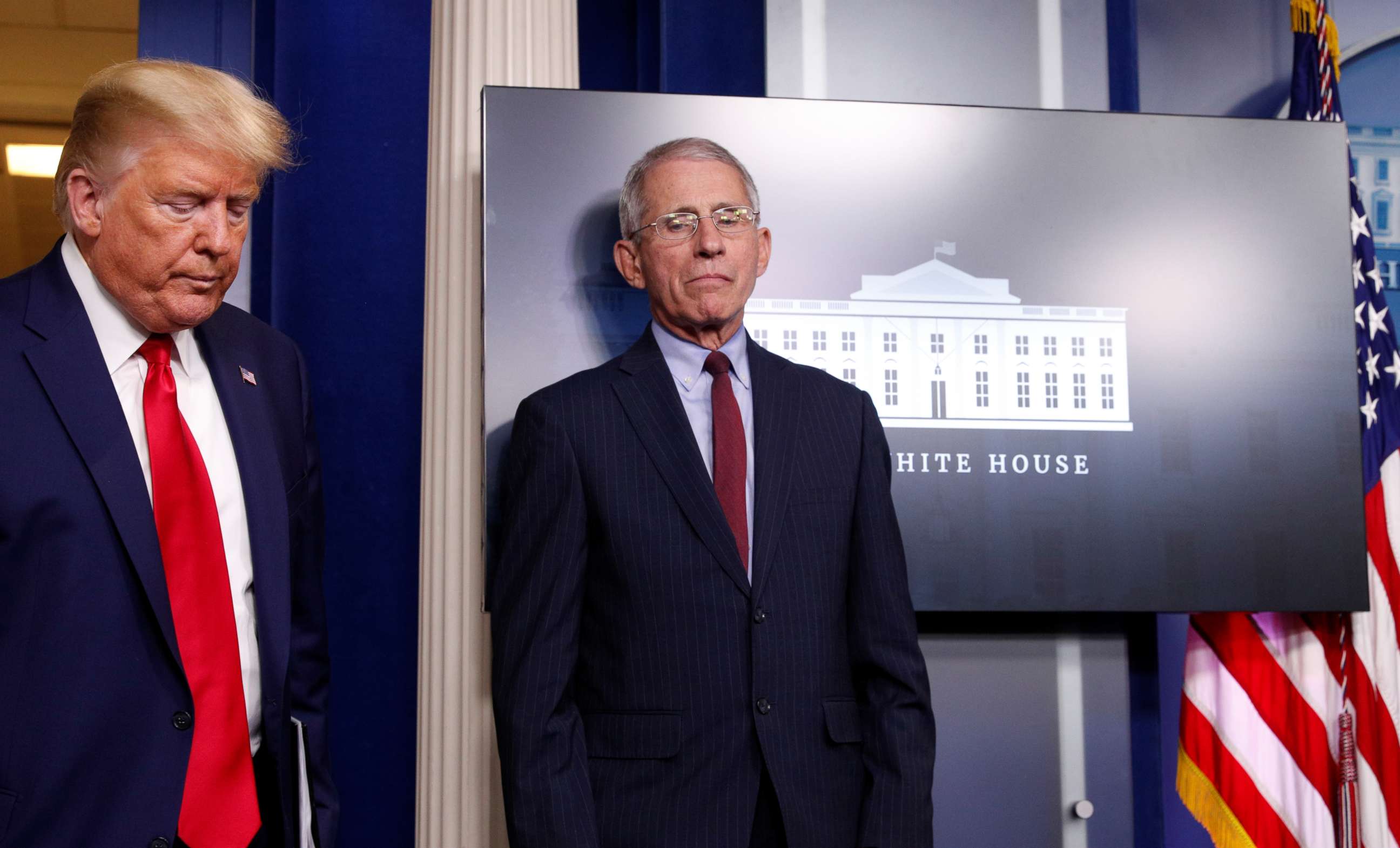 PHOTO: President Donald Trump walks past Dr. Anthony Fauci, Director of the National Institute of Allergy and Infectious Diseases, as the president arrives for the daily coronavirus response briefing at the White House in Washington, March 31, 2020. 