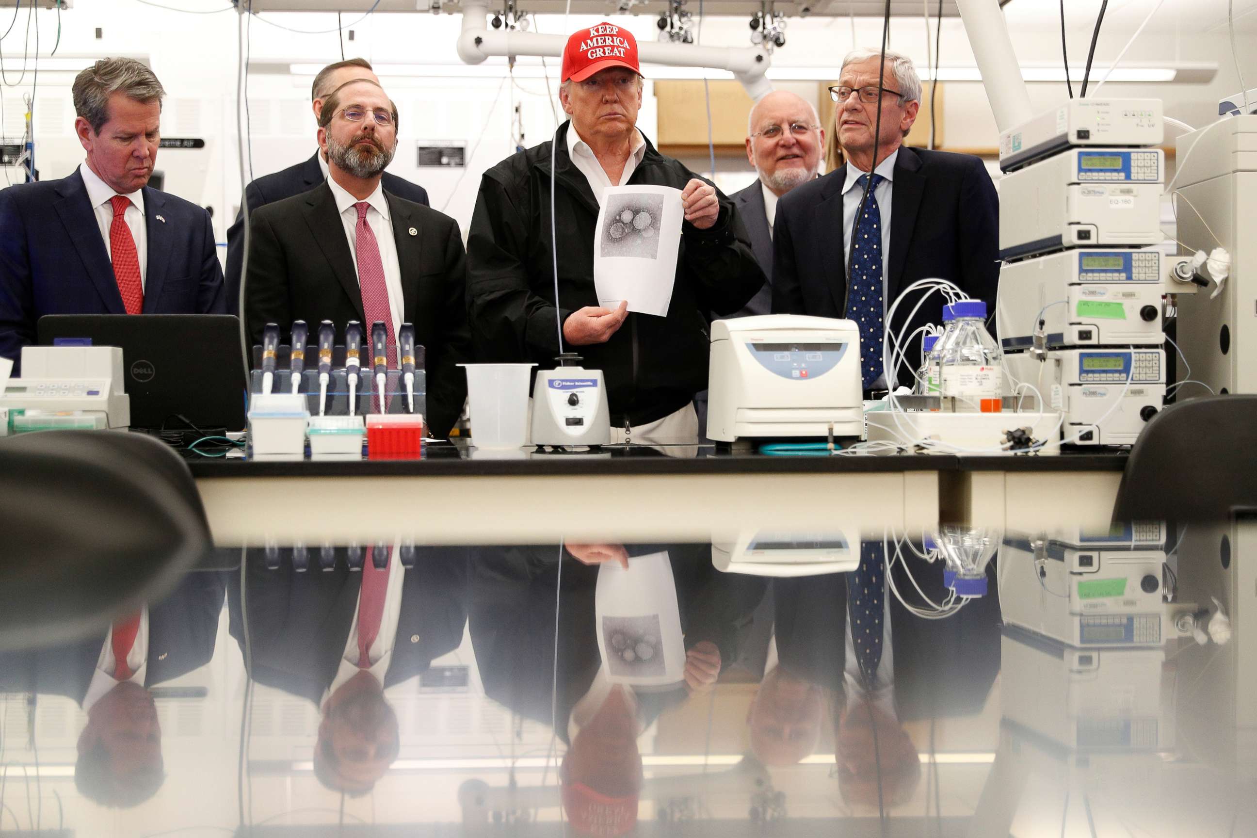 PHOTO: President Donald Trump displays a photo of the COVID-19 Coronavirus during a tour of the Center for Disease Control in Atlanta, March 6, 2020.