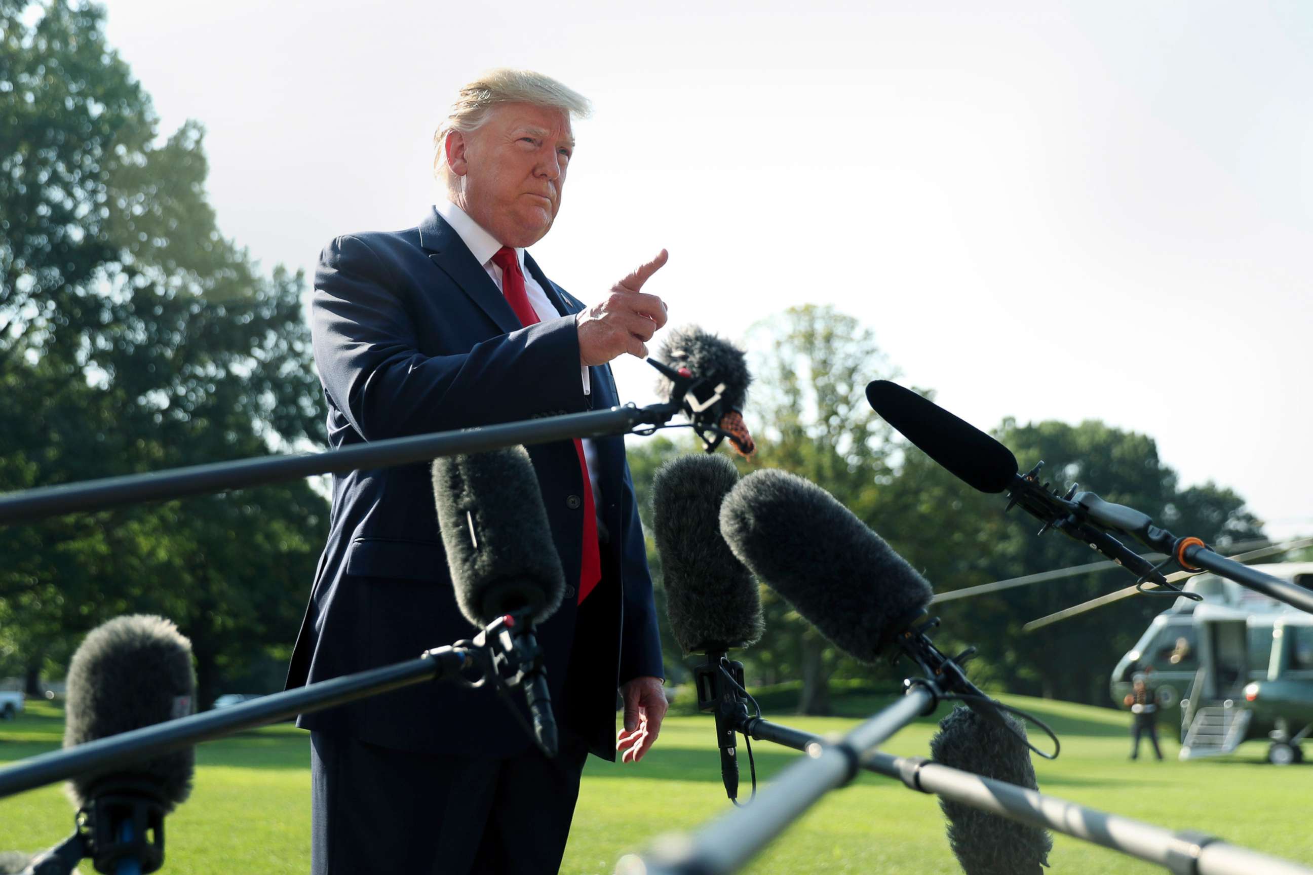 PHOTO: President Donald Trump talks to the press before boarding Marine One for a trip to Dayton, Ohio, and El Paso, Texas, to meet with first responders and console family members and survivors from two recent mass shootings, Aug. 7, 2019.