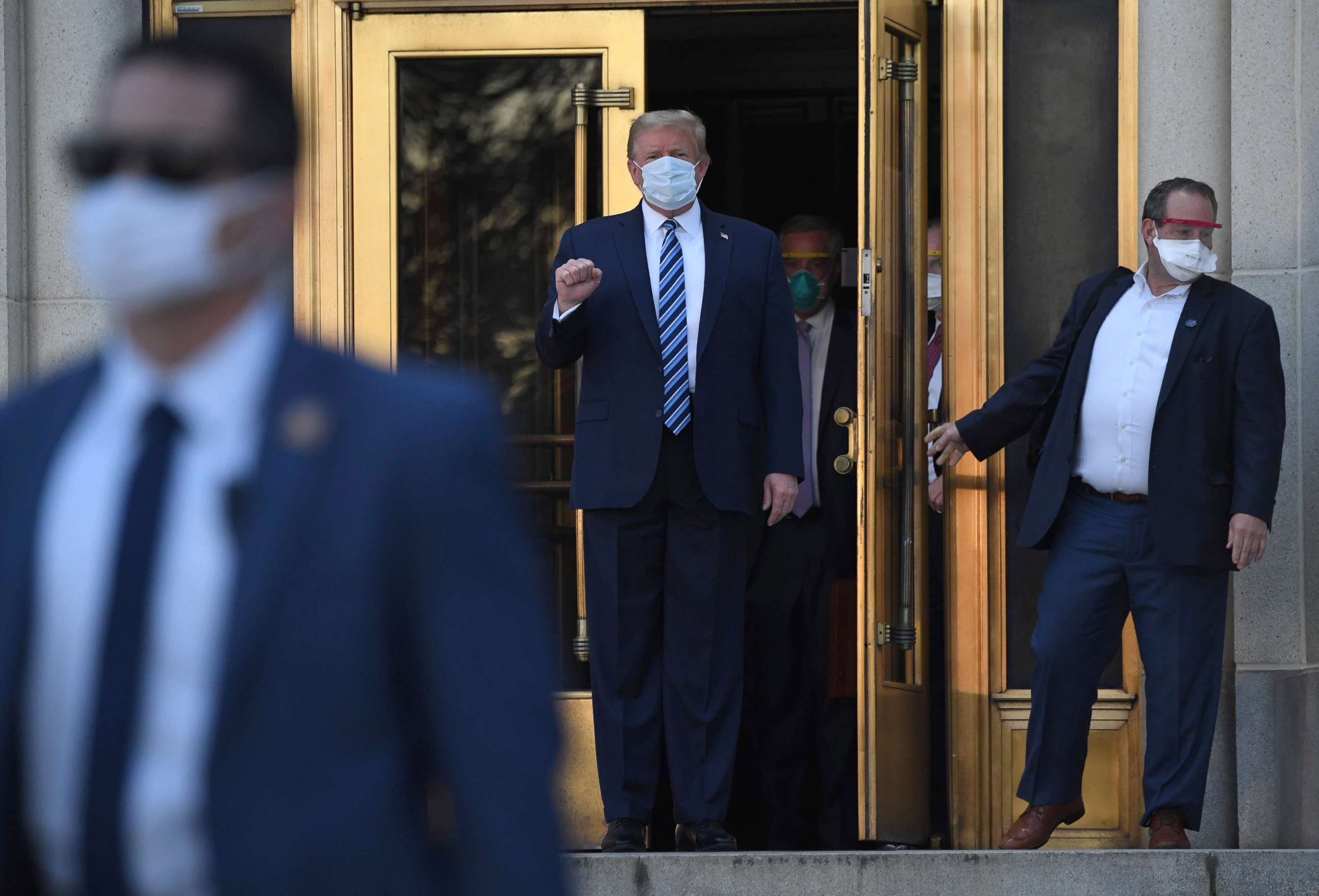 PHOTO: President Donald Trump pumps his fist as he walks out of Walter Reed Medical Center in Bethesda, Md., Oct. 5, 2020, to return to the White House after being discharged.