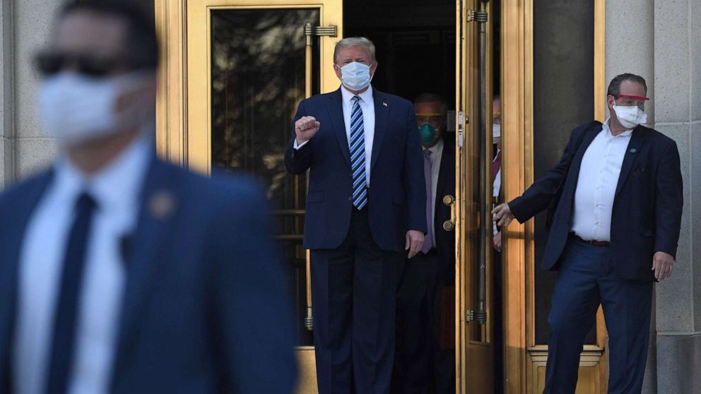 PHOTO: President Donald Trump pumps his fist as he walks out of Walter Reed Medical Center in Bethesda, Md., Oct. 5, 2020, to return to the White House after being discharged.