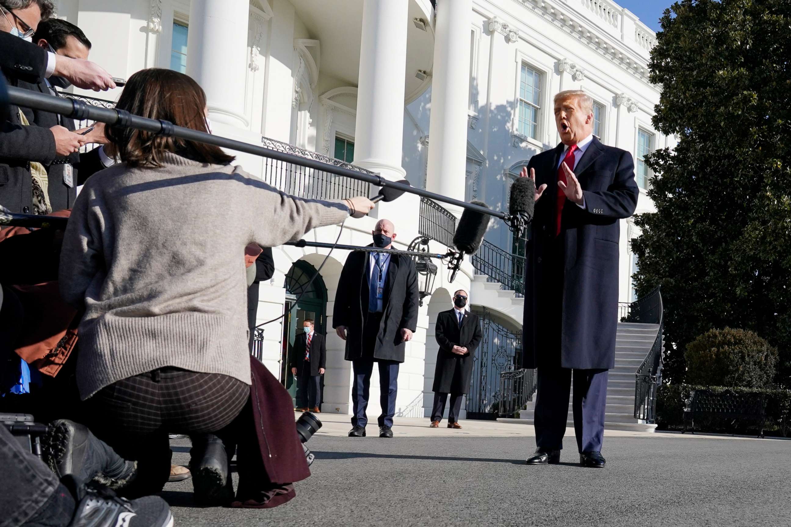 PHOTO: President Donald Trump talks to the media before boarding Marine One on the South Lawn of the White House, Jan. 12, 2021, in Washington.