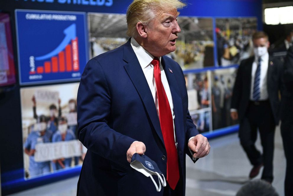 PHOTO: In this May 21, 2020, file photo, President Donald Trump  holds a mask as he speaks during a tour of the Ford Rawsonville Plant in Ypsilanti, Mich.