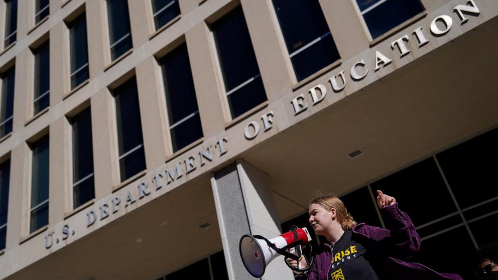 PHOTO: A demonstrator attends a Defend Our Schools rally to protest U.S. President Donald Trump's executive order to shut down the U.S.Department of Education outside its building in Washington, D.C., U.S., March 21, 2025.