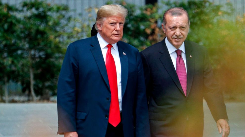 President Donald Trump speaks to Turkey's President Recep Tayyip Erdogan during the opening ceremony of the NATO summit at the NATO headquarters in Brussels.