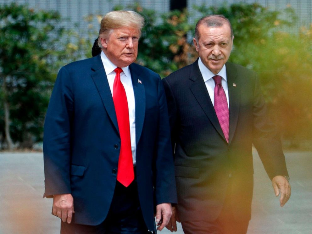 PHOTO: President Donald Trump speaks to Turkeys President Recep Tayyip Erdogan during the opening ceremony of the NATO summit at the NATO headquarters in Brussels.