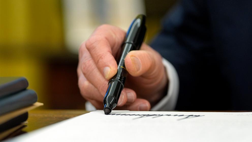 PHOTO: President Donald Trump signs an executive order in the Oval Office at the White House, Feb. 10, 2025, in Washington.