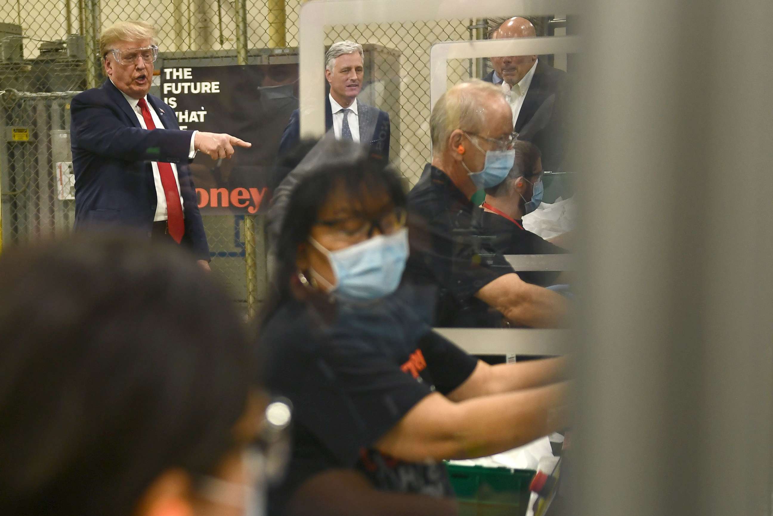 PHOTO: President Donald Trump (L) participates in a tour of a Honeywell International plant that manufactures personal protective equipment in Phoenix, May 5, 2020.