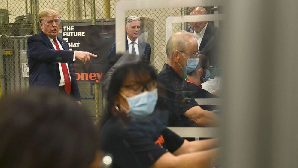 PHOTO: President Donald Trump (L) participates in a tour of a Honeywell International plant that manufactures personal protective equipment in Phoenix, May 5, 2020.