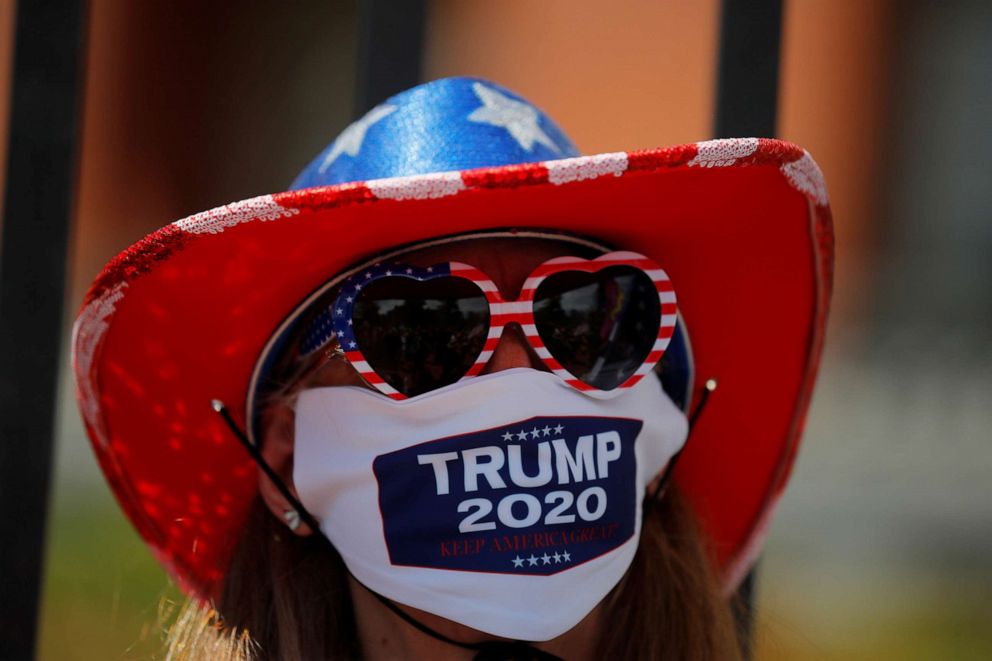 PHOTO: Donna Harkness wears a mask with "Trump 2020" printed on it at a demonstration to demand the lifting of restrictions imposed by state and local officials to fight the spread of the coronavirus in Boston, May 30, 2020.