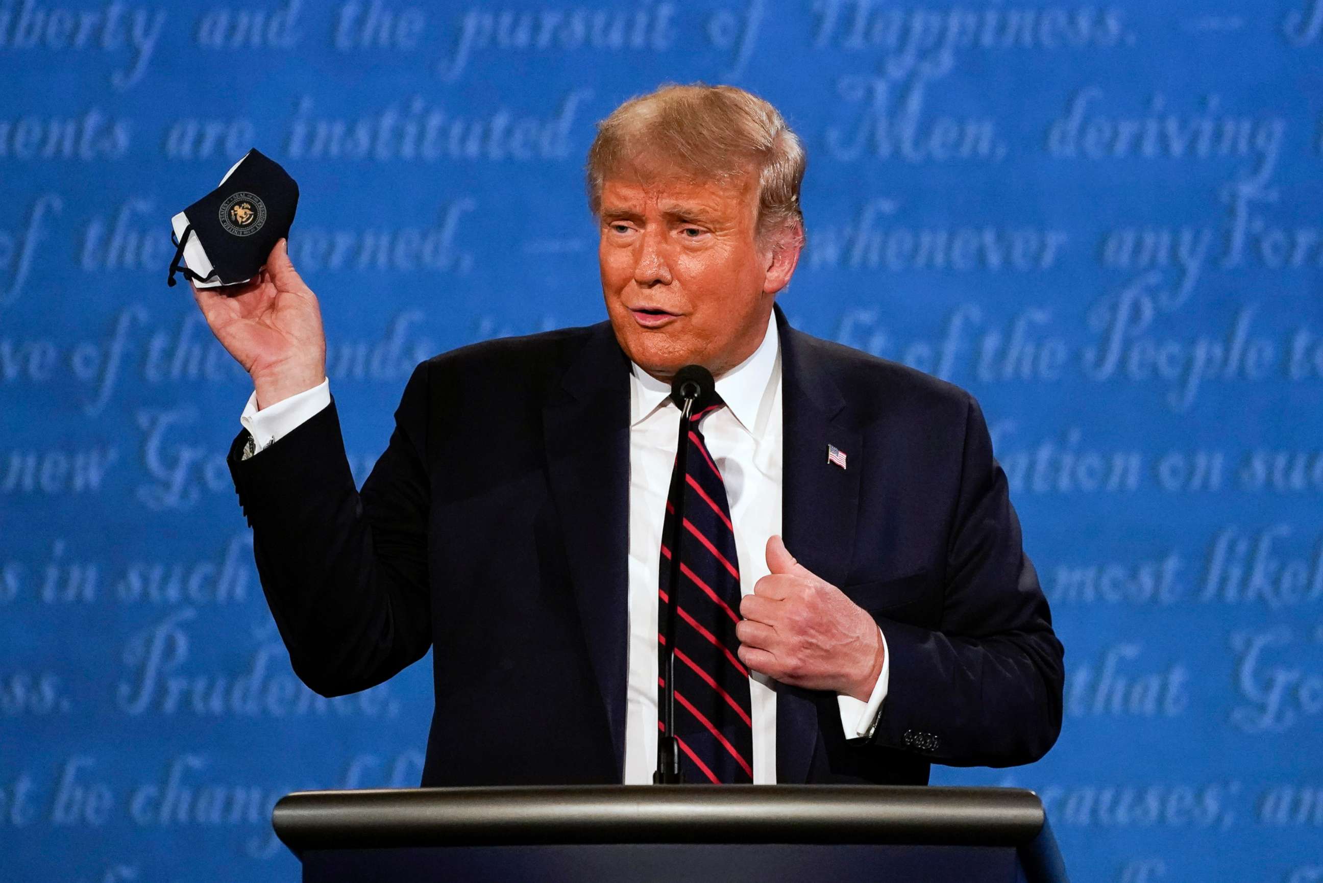 PHOTO:President Donald Trump holds up his face mask during the first presidential debate at Case Western University and Cleveland Clinic, in Cleveland, Sept. 29, 2020.