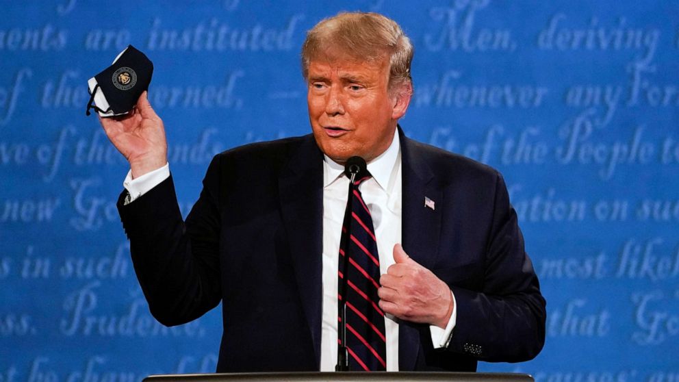 PHOTO:President Donald Trump holds up his face mask during the first presidential debate at Case Western University and Cleveland Clinic, in Cleveland, Sept. 29, 2020.