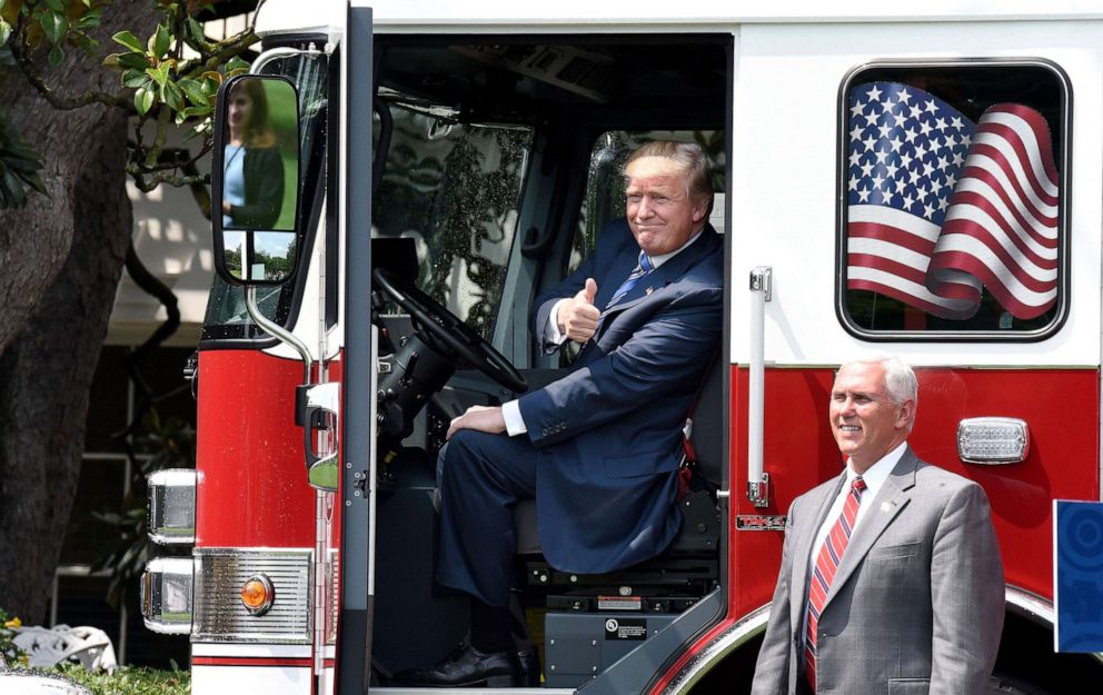 PHOTO: President Donald Trump gives the thumbs-up sitting inside a  fire truck as Vice President Mike Pence looks on during a "Made in America" product showcase event on the South Lawn at the White House in Washington, D.C, July 17, 2017. 