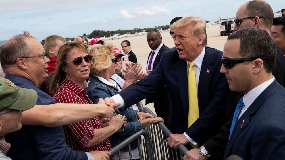PHOTO: President Donald Trump shakes hands with supporters upon arrival at the Orlando Sanford International Airport, March 9, 2020 in Orlando, Fla.