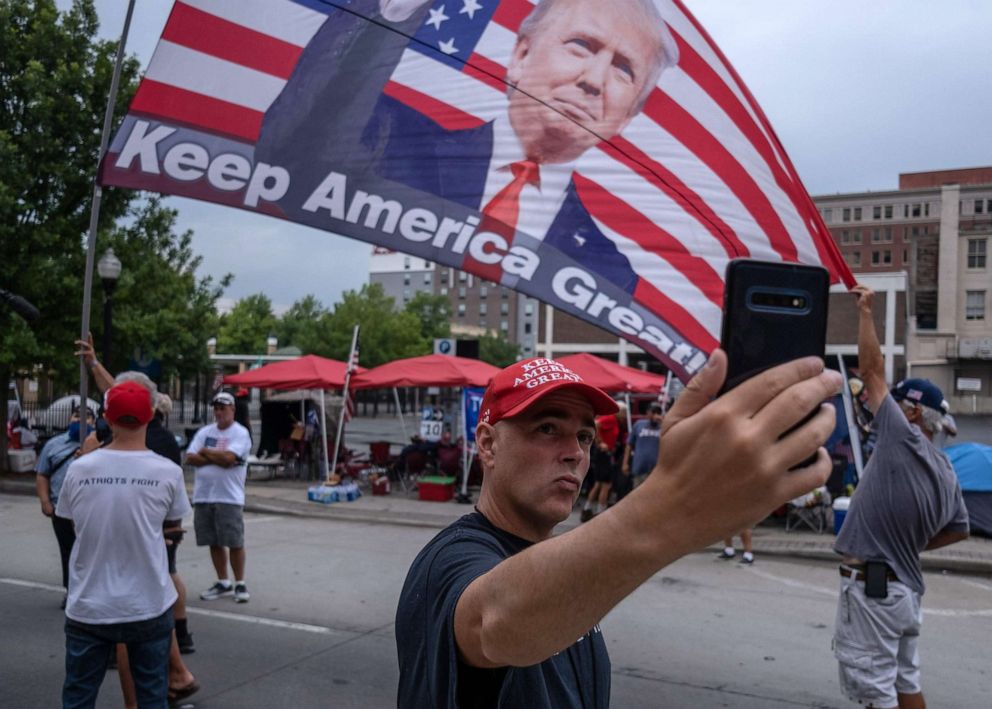 PHOTO: A supporter of President Donald Trump takes a selfie near the BOK Center on June 19, 2020, in Tulsa, Okla.