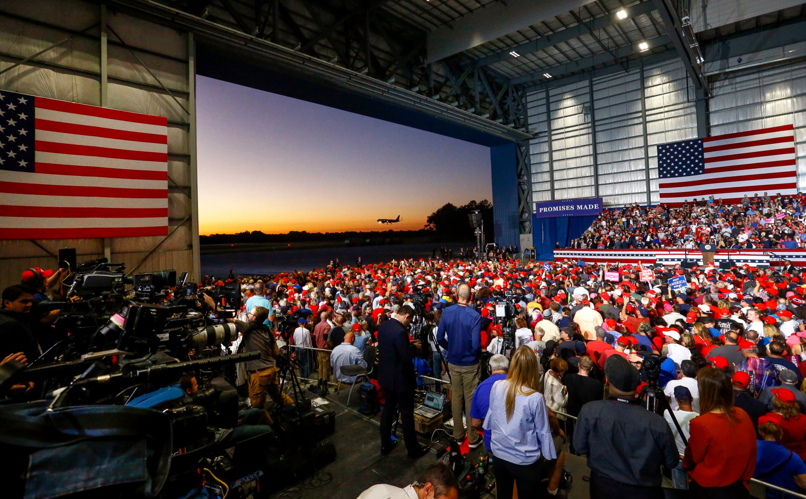 PHOTO: Supporters watch as Air Force One lands outside the hanger where they wait for President Donald Trump to speak at a rally, Saturday, Nov. 3, 2018, in Pensacola, Fla. 