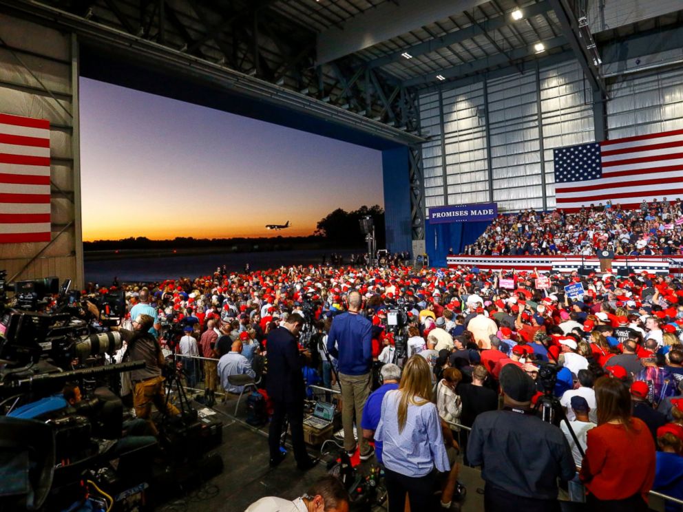 PHOTO: Supporters watch Air Force One land outside the hangar where they wait for President Donald Trump to speak at a rally on Saturday, Nov. 3, 2018, in Pensacola, Florida. 