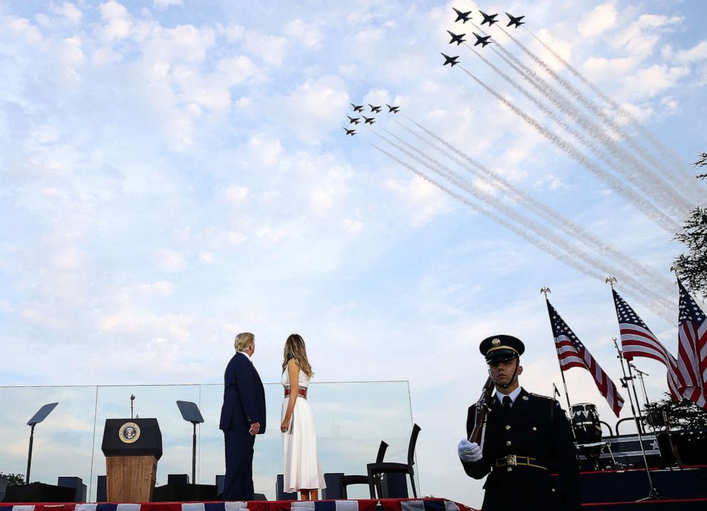 PHOTO: President Donald Trump and first lady Melania Trump watch the U.S. Navy Blue Angels and U.S. Air Force Thunderbirds perform a flyover near the White House on July 4, 2020 in Washington, D.C.