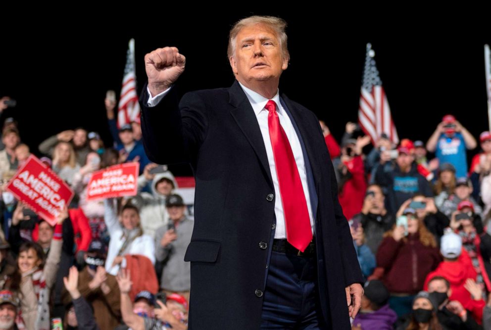 PHOTO: President Donald Trump holds up his fist as he leaves the stage at the end of a rally to support Republican Senate candidates at Valdosta Regional Airport in Valdosta, Georgia, Dec. 5, 2020.