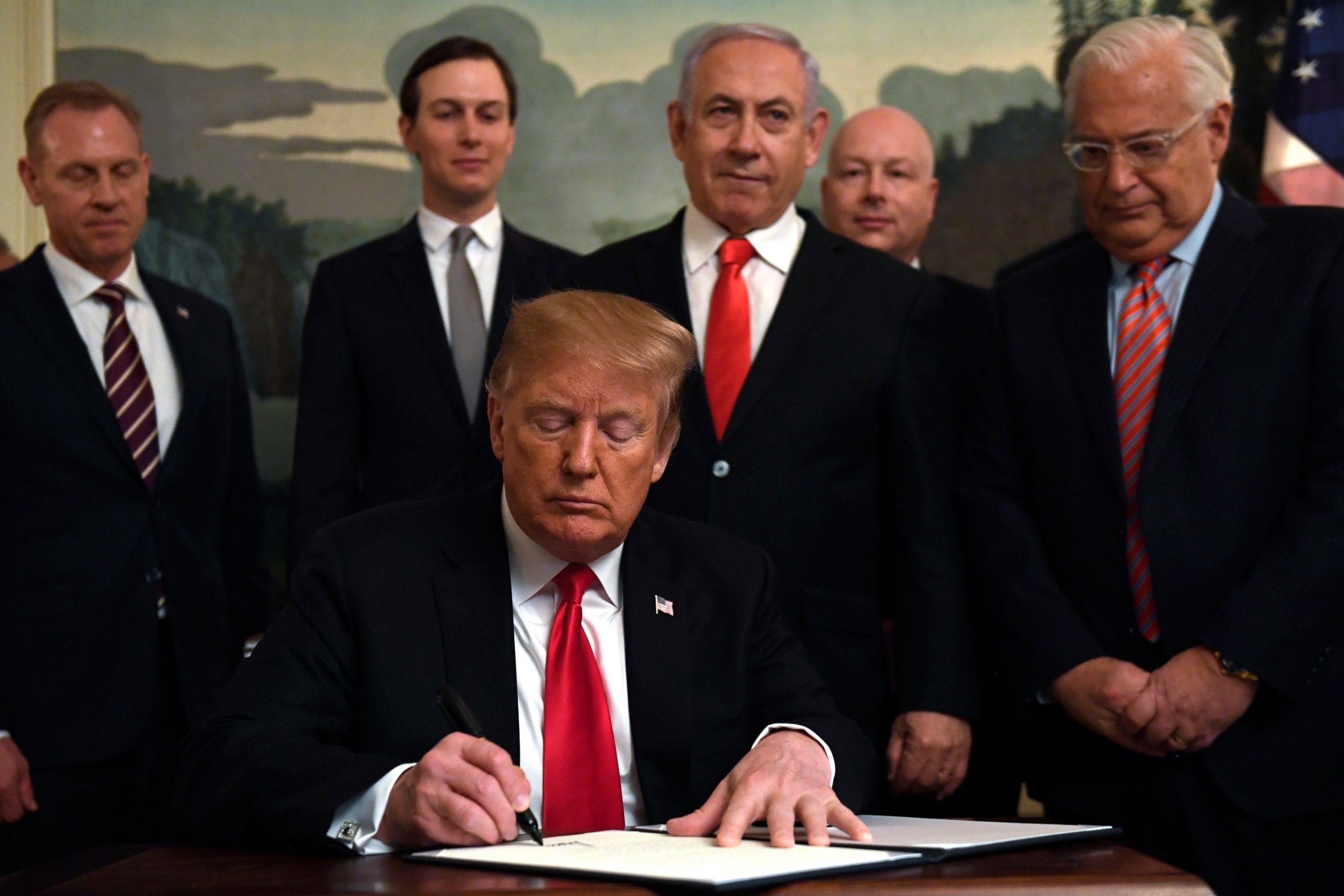 PHOTO: President Donald Trump, front, signs a proclamation in the Diplomatic Reception Room at the White House in Washington, Monday, March 25, 2019. Trump signed an official proclamation formally recognizing Israel's sovereignty over the Golan Heights. 