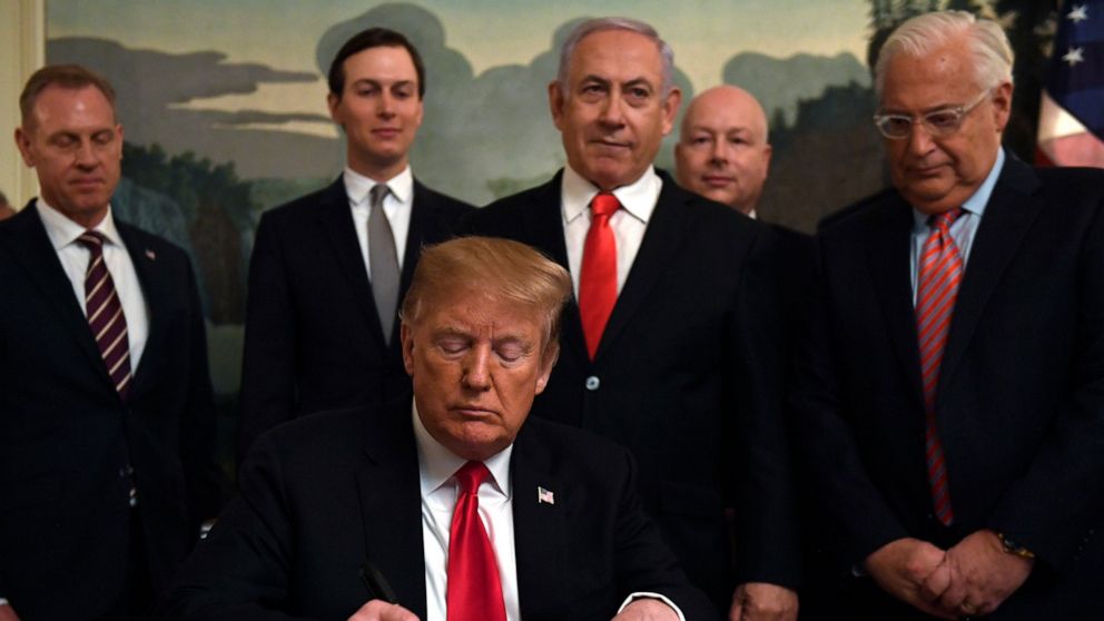 PHOTO: President Donald Trump, front, signs a proclamation in the Diplomatic Reception Room at the White House in Washington, Monday, March 25, 2019. Trump signed an official proclamation formally recognizing Israel's sovereignty over the Golan Heights. 