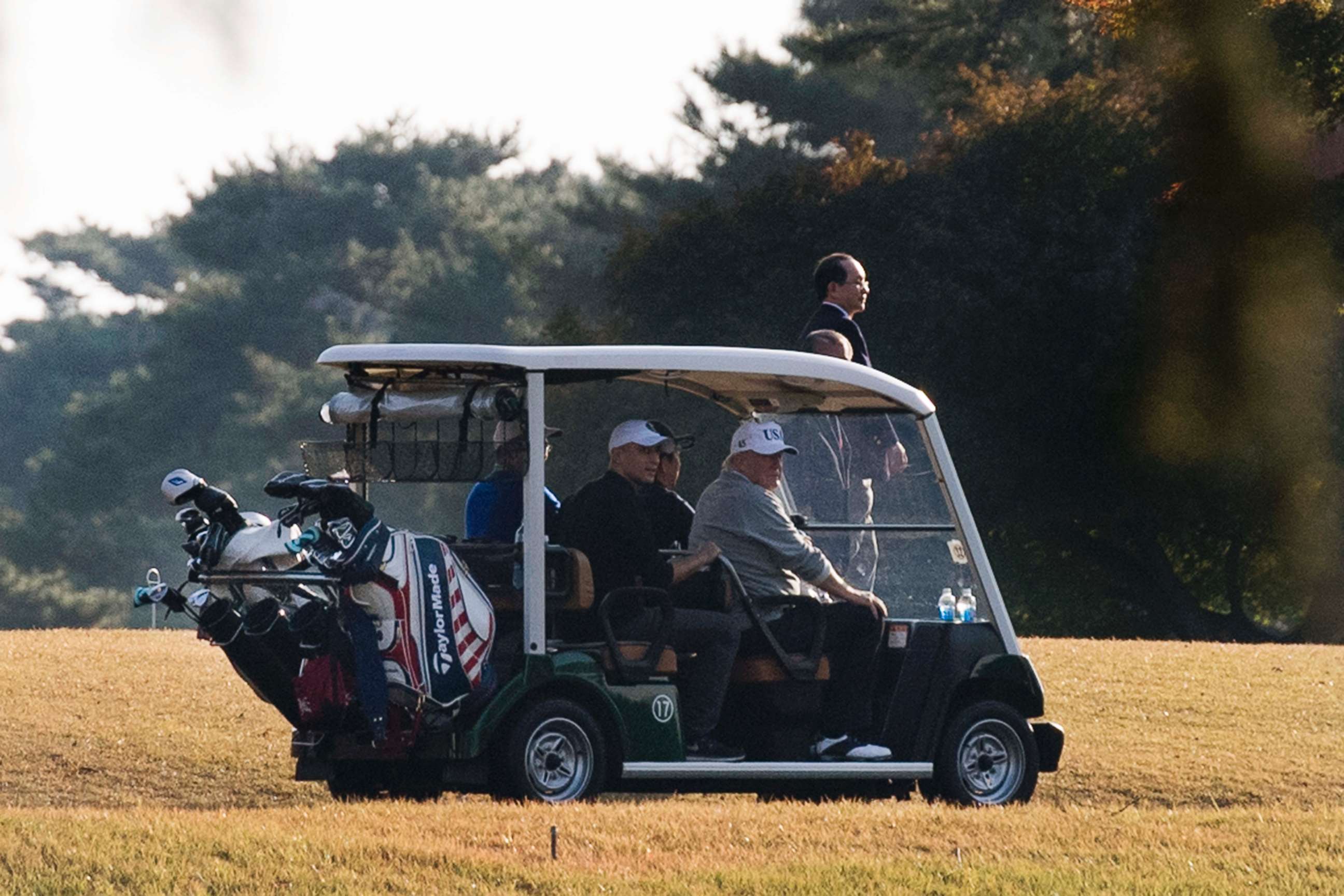 PHOTO: President Donald Trump (front R) and Japanese Prime Minister Shinzo Abe (front L) return in a golf cart after playing a round of golf at the Kasumigaseki Country Club Golf Course in Kawagoe, Saitama prefecture, outside Tokyo, Nov. 5, 2017.