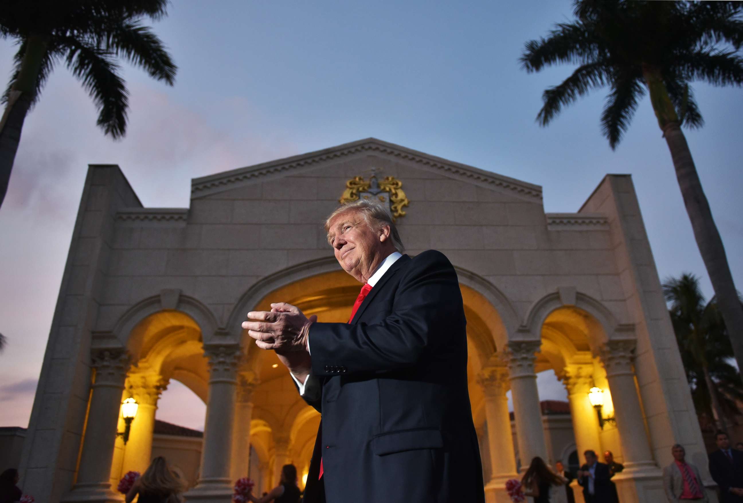 PHOTO: President Donald Trump watches the Palm Beach Central High School marching band perform as it greets him upon his arrival to watch the Super Bowl at Trump International Golf Club Palm Beach in West Palm Beach, Fla., Feb. 5, 2017.