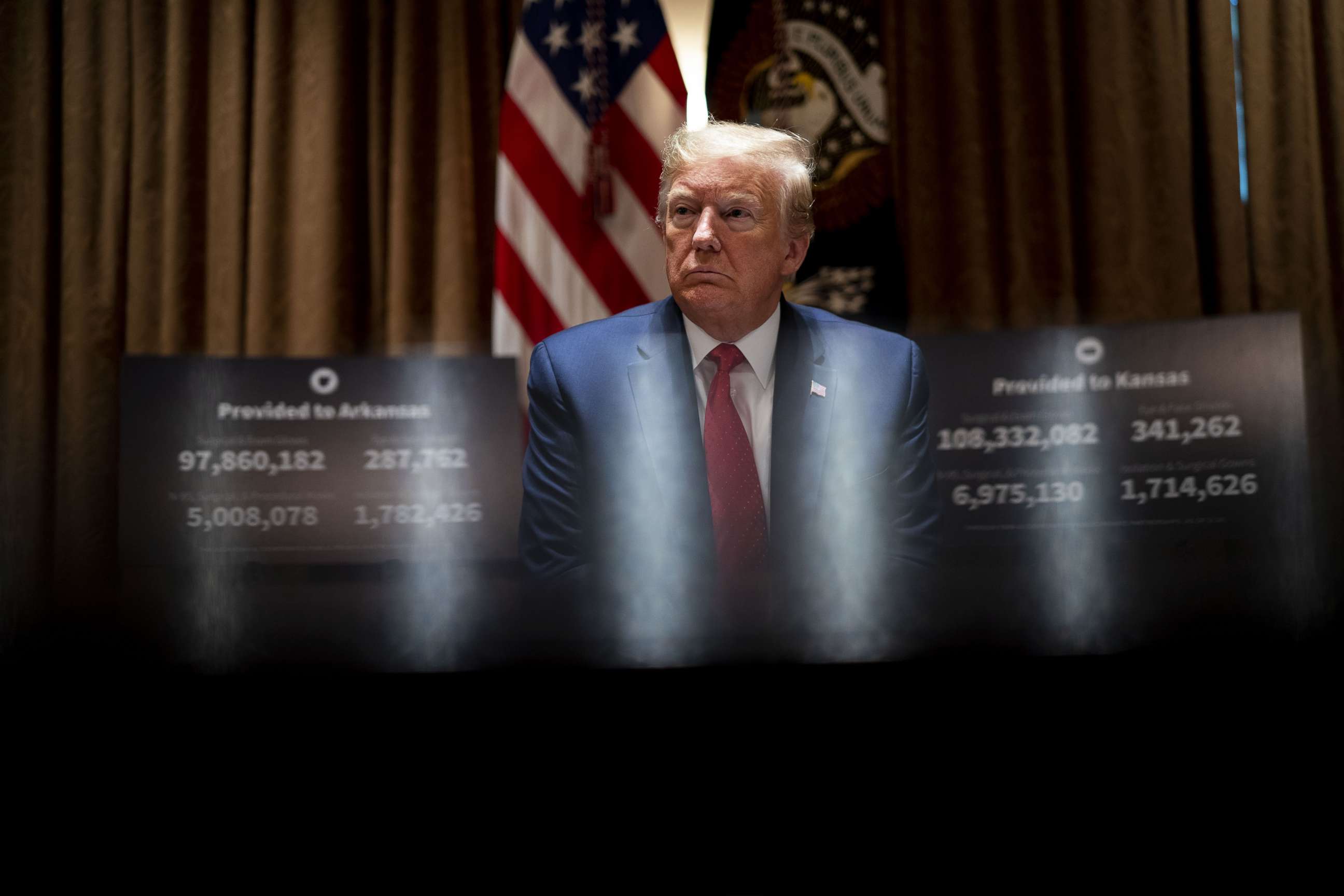 PHOTO: President Donald Trump listens as he attends a meeting with the Arkansas Gov. Asa Hutchinson and Kansas Governor Laura Kelly in the Cabinet Room of the White House May 20, 2020 in Washington.