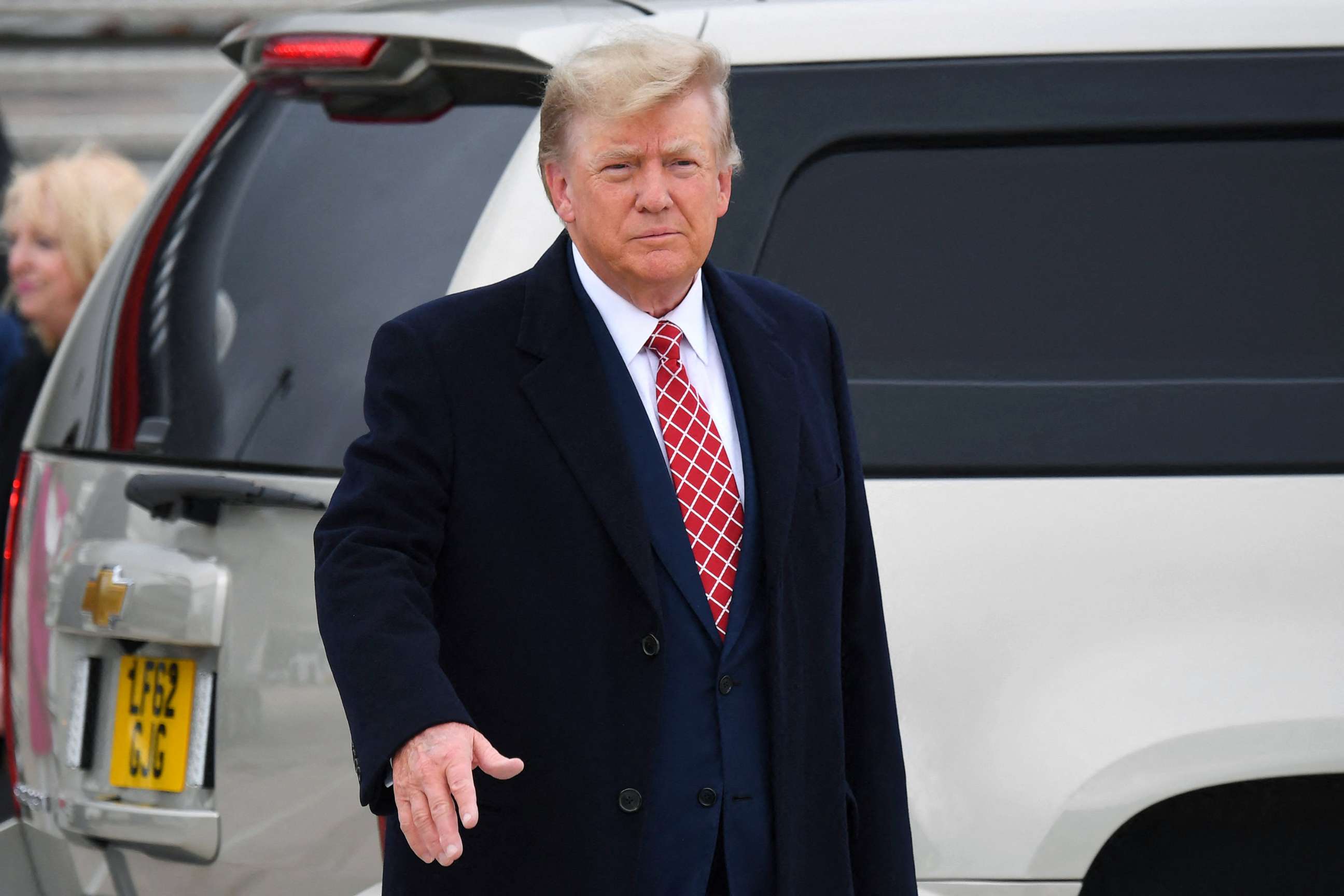 PHOTO: Former President Donald Trump gestures to members of the media on the tarmac after disembarking his plane at Aberdeen airport on the north-east coast of Scotland on May 1, 2023.