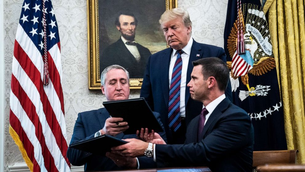 PHOTO: President Donald Trump watches acting DHS Secretary Kevin McAleenan, right, and Guatemalan Interior Minister Enrique Degenhart as they sign a safe third country agreement, July 26, 2019, in Washington.