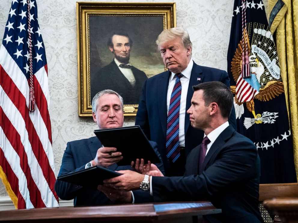 PHOTO: President Donald Trump watches acting DHS Secretary Kevin McAleenan, right, and Guatemalan Interior Minister Enrique Degenhart as they sign a safe third country agreement, July 26, 2019, in Washington.