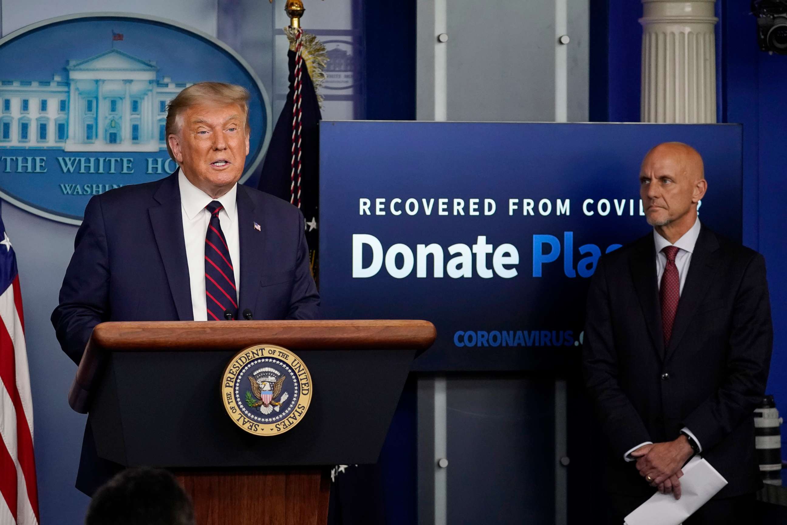 PHOTO: President Donald Trump speaks as Stephen Hahn, FDA commissioner, listens during a media briefing in the James Brady Briefing Room of the White House, Aug. 23, 2020, in Washington.