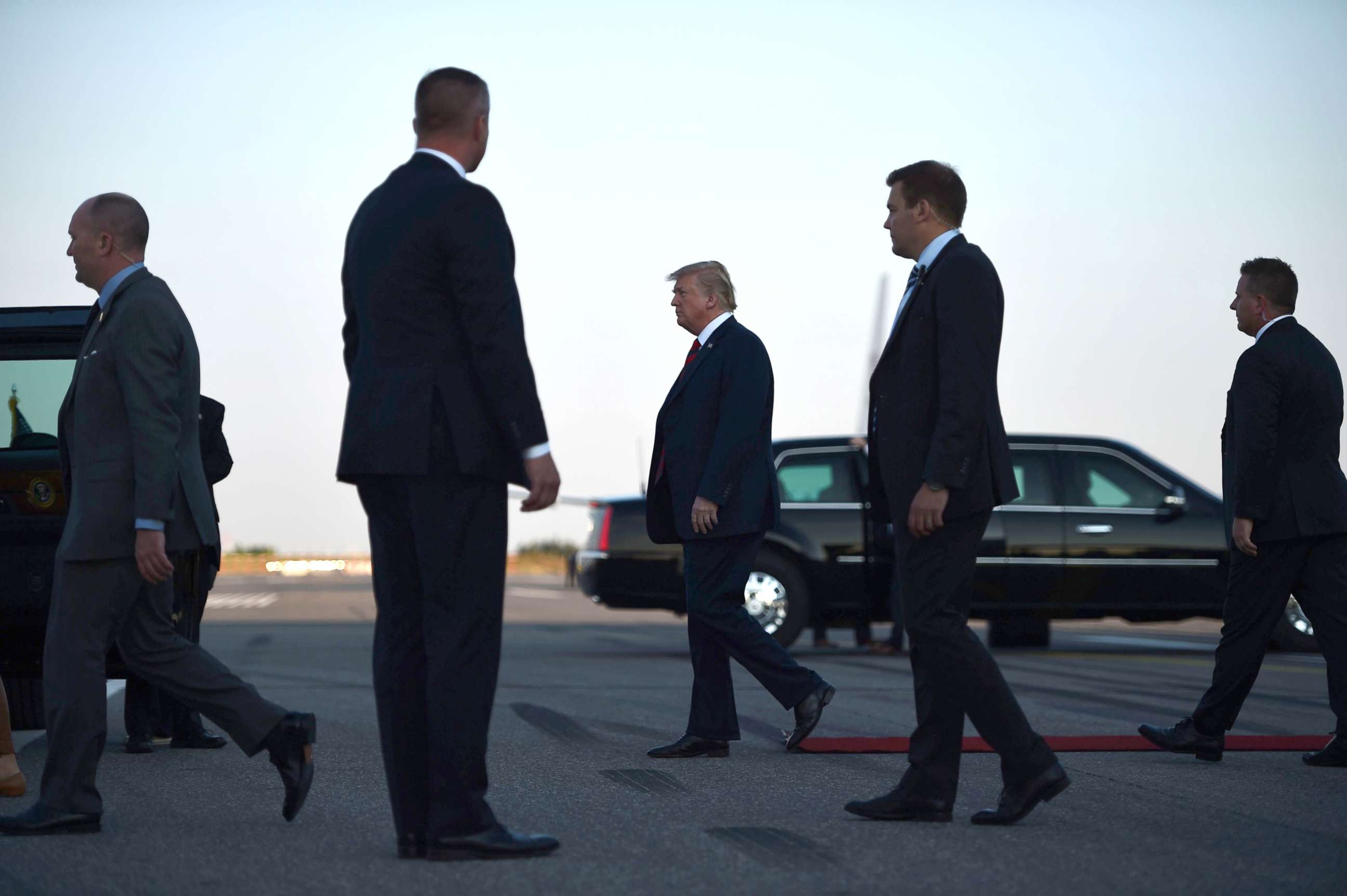 PHOTO: US President Donald Trump walks towards the Presidential car upon arrival at Helsinki-Vantaa Airport in Helsinki, July 15, 2018, on the eve of a summit in Helsinki between the US President and his Russian counterpart.