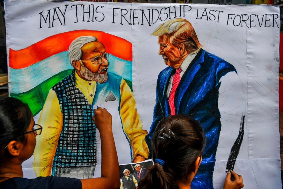 PHOTO: Students paint on canvas depictions of President Donald Trump and India's Prime Minister Narendra Modi, in the street in Mumbai on Feb. 21, 2020, ahead of Trump's visit to India.