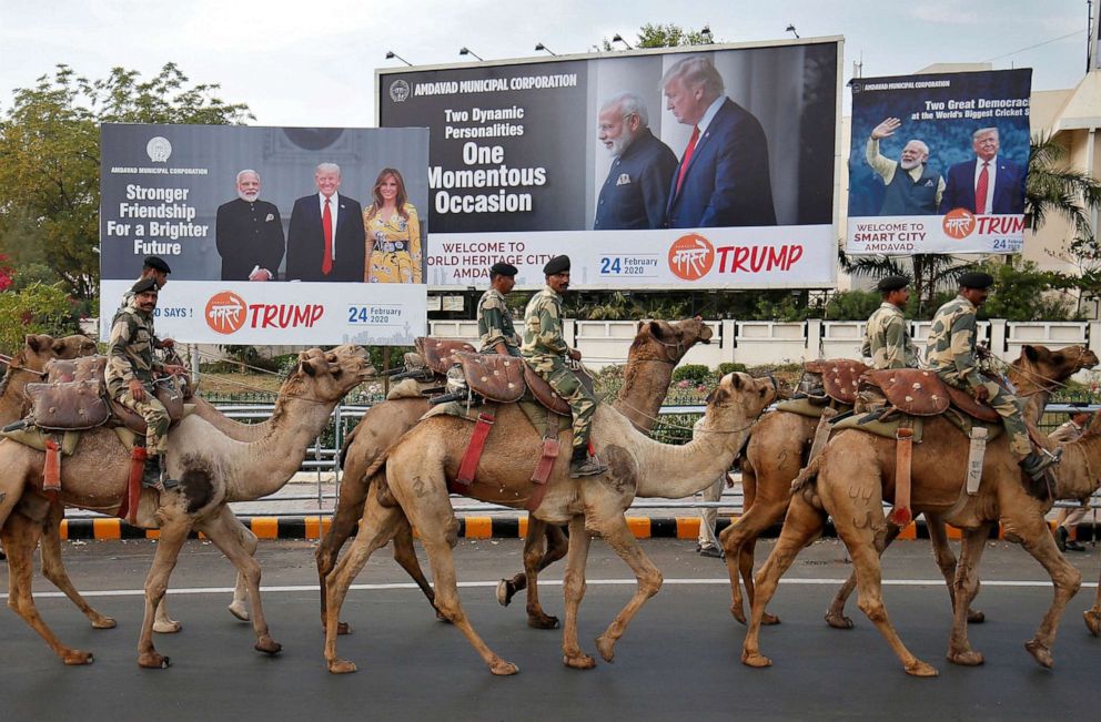 PHOTO: Border Security Force soldiers ride their camels past billboards with the images of India's Prime Minister with President and first lady Trump ahead of Trump's visit, in Ahmedabad, India, Feb. 21, 2020.